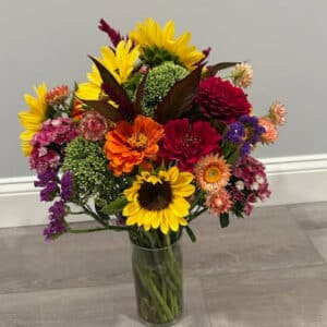 A vase with fresh cut flowers as part of a monthly flower subscription.
