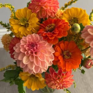 A vase with fresh cut flowers as part of a monthly flower subscription.